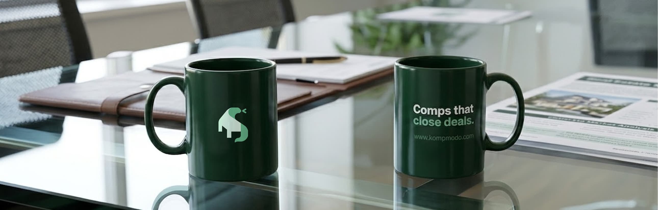 Kompmodo branded mugs on desk